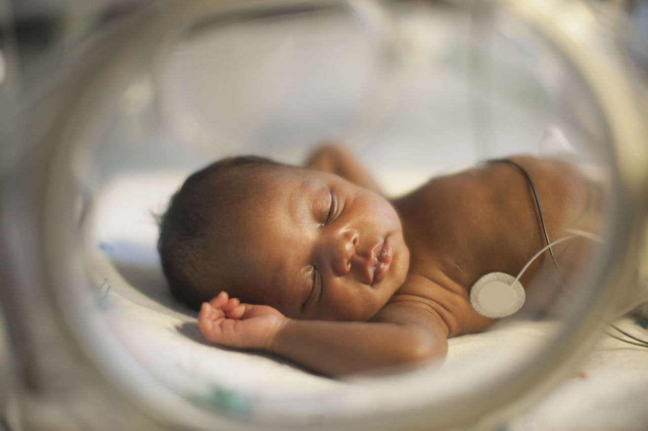Premature black baby inside incubator