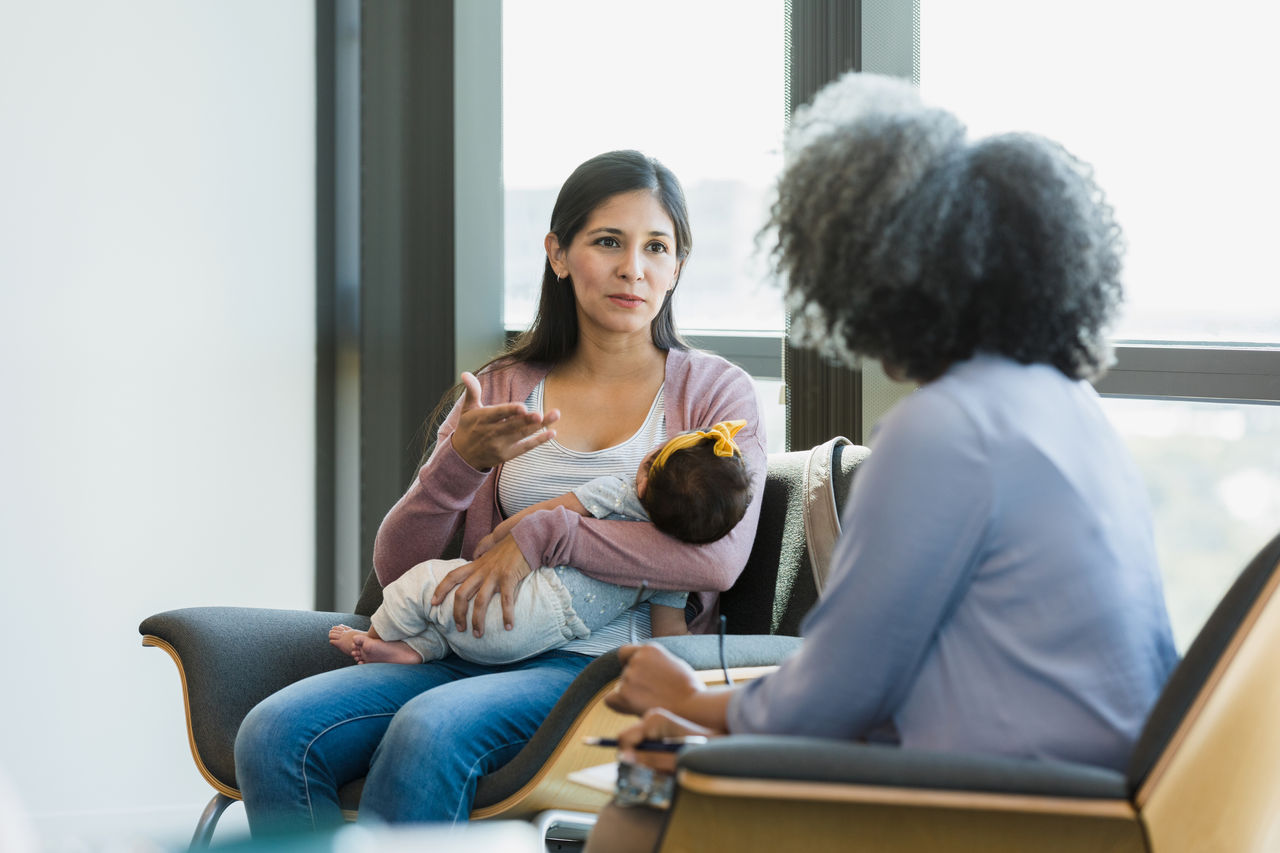 Woman gestures while sharing struggles with therapist - stock photo