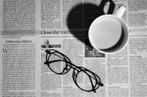 News paper with glasses and coffee cup