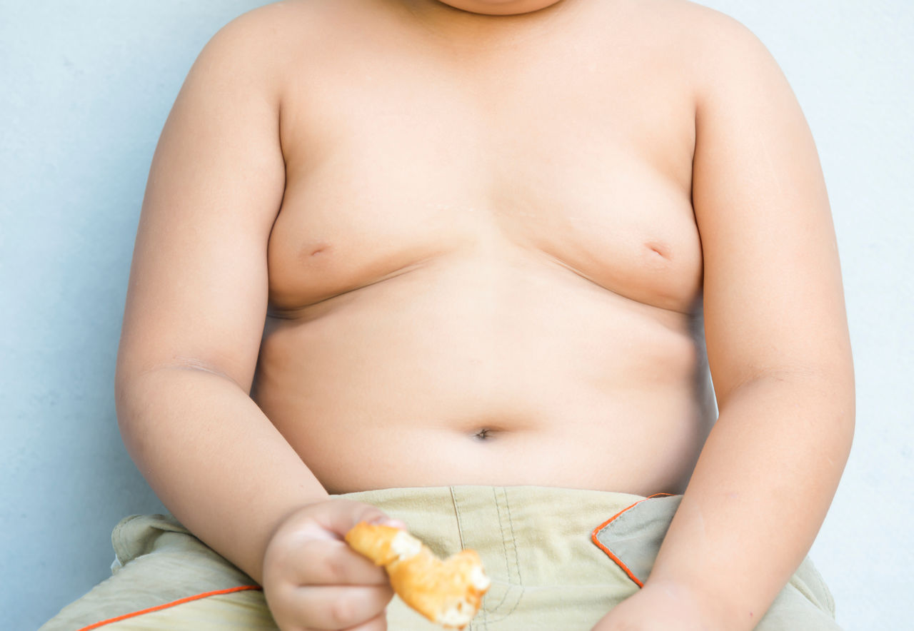 big obese asian fay boy on gray background