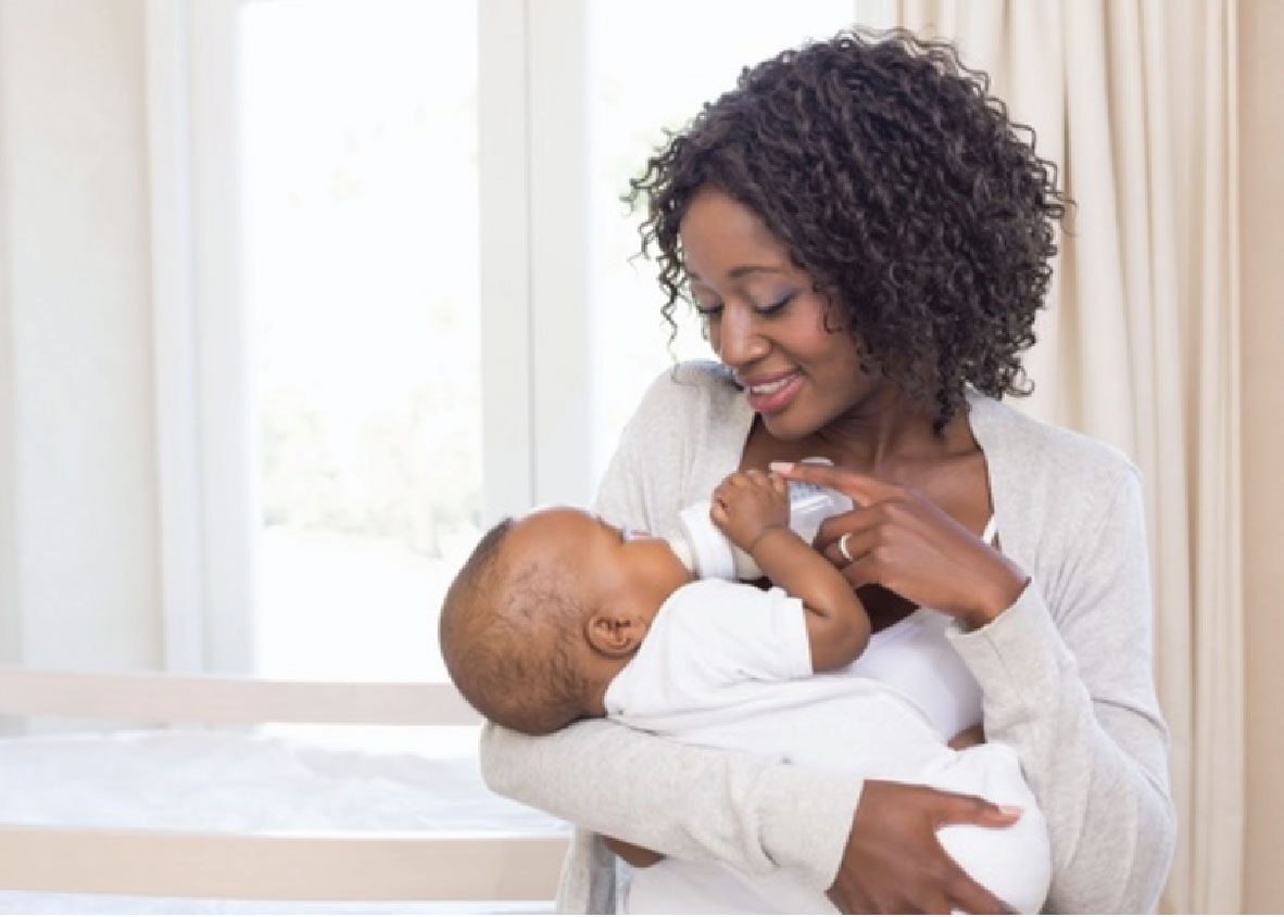 Mother Smiling and Breastfeeding Baby