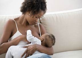 Mom breastfeeding baby in the cradle hold Breastfeeding Education: Tips & Techniques for Getting Started